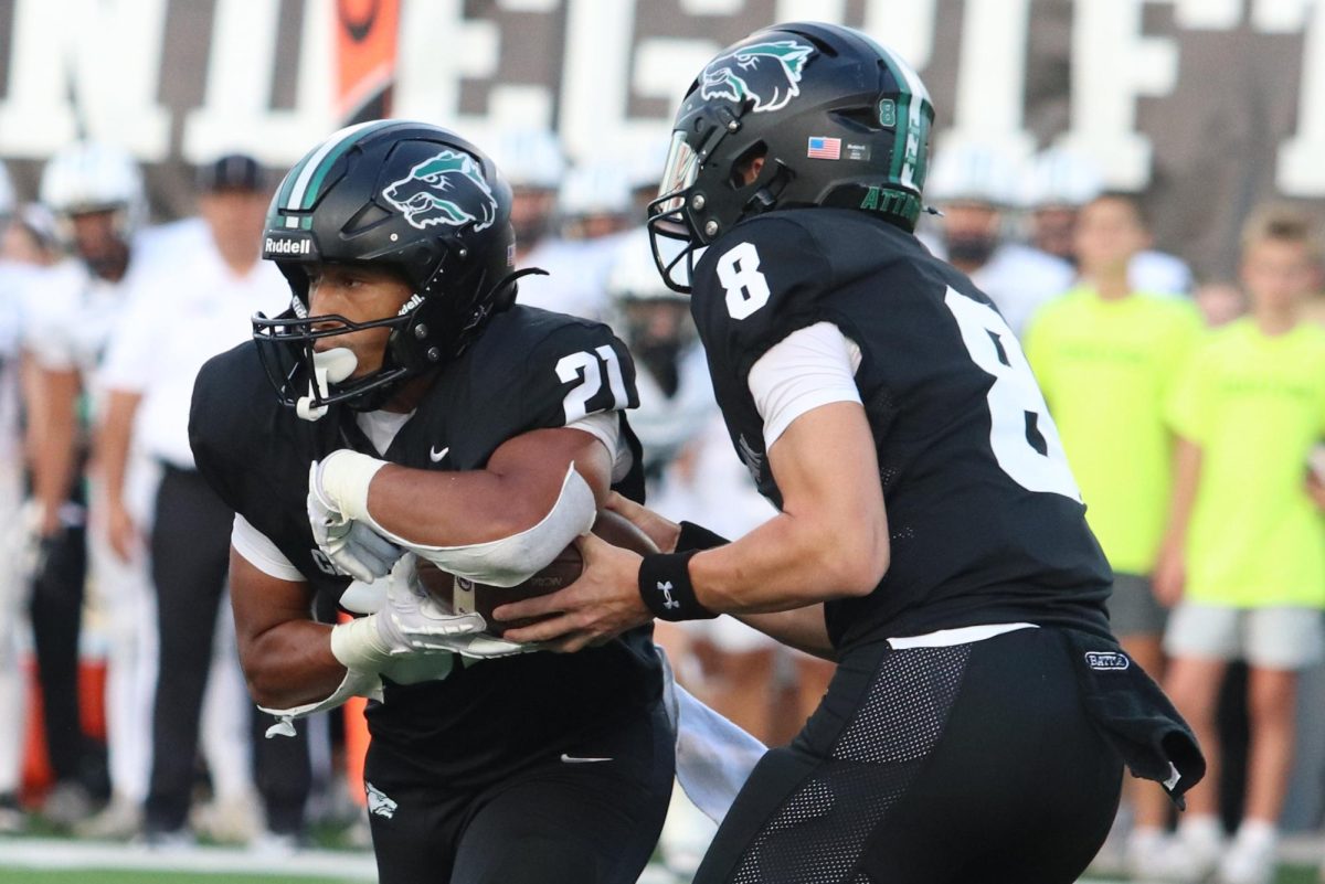 Clutching the ball to his chest, senior running back Trae Hill takes a handoff from junior quarterback David Cooper in last year’s 49-46 victory against Vandegrift. This year, Cedar Park plays Vandegrift Friday at Monroe Stadium, with both teams entering the game at 0-1. “[There were] a lot of good things but also some bad things that we could work on,” Cooper said after last week’s loss. “Our offense is going to keep on working and so is our defense. We’re going to be a different team next week.”