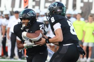 Clutching the ball to his chest, senior running back Trae Hill takes a handoff from junior quarterback David Cooper in last year’s 49-46 victory against Vandegrift. This year, Cedar Park plays Vandegrift Friday at Monroe Stadium, with both teams entering the game at 0-1. “[There were] a lot of good things but also some bad things that we could work on,” Cooper said after last week’s loss. “Our offense is going to keep on working and so is our defense. We’re going to be a different team next week.”