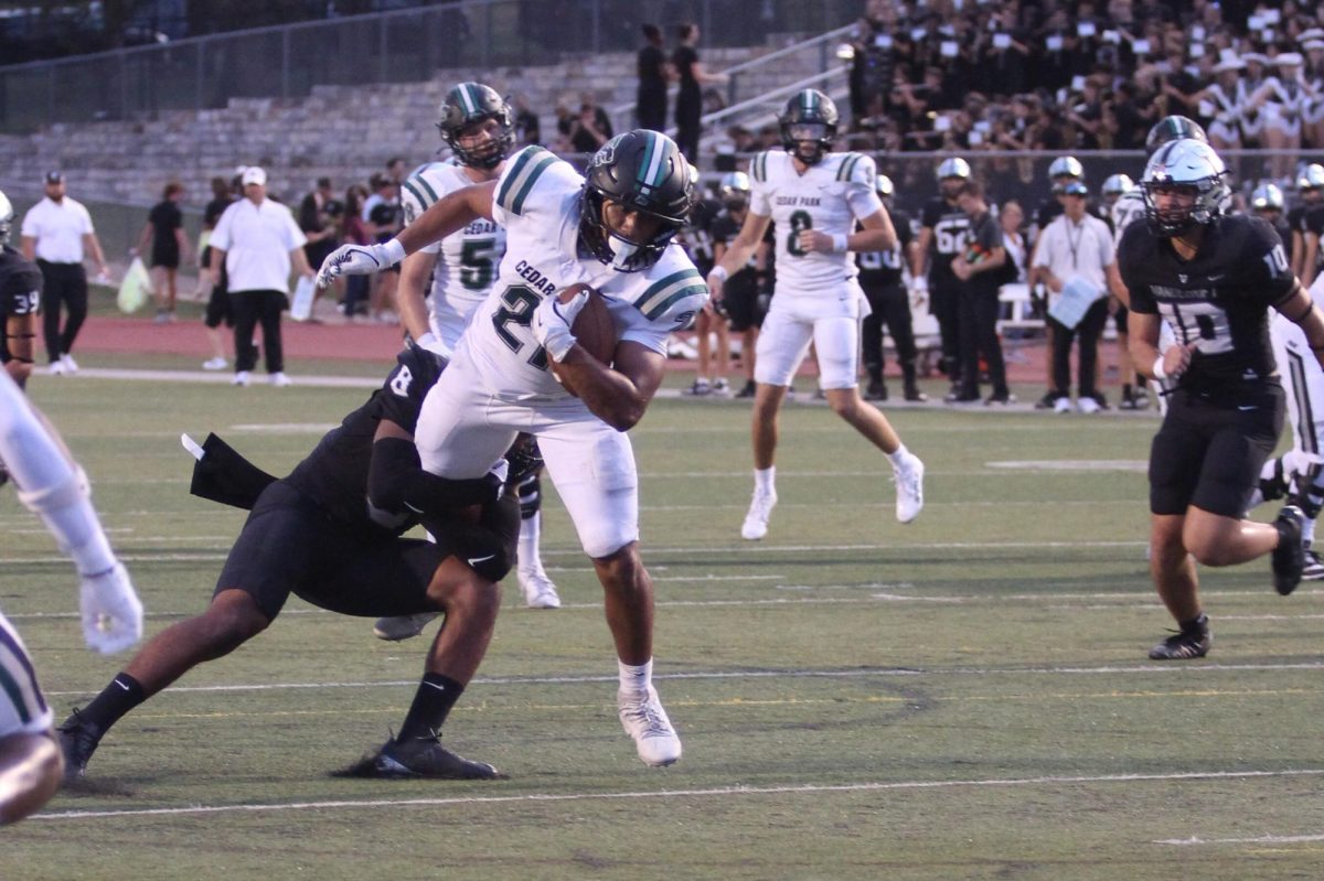 As he sprints with the ball, senior running back Trae Hill breaks a tackle during Friday’s 35-14 loss against the Vandegrift Vipers. Hill ran for 135 yards and two touchdowns during the game. “[Scoring] was electric,” Hill said. “It always feels good to score, but the O-line did everything.”