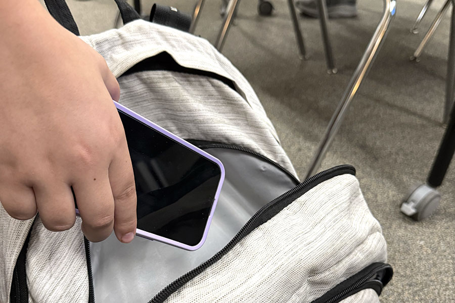 Opening their backpack, a student puts away their phone. The Texas state legislature passed House Bill 1481 this fall, which banned phones in public schools. "Hopefully we'll see more engagement and instruction in the classroom and more consistent engagement throughout the lesson,” Dean of Instruction Jennifer Colman said. “People defaulted to using their phones, so hopefully it'll be more consistent in engagement, less distraction. And I think it's good for all of us to take breaks from our phones.”