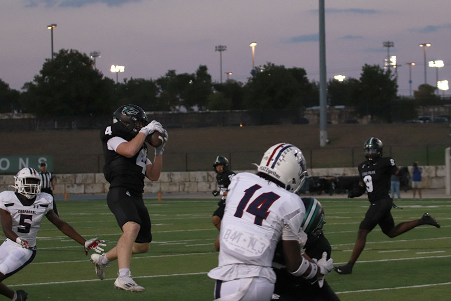 Jumping off the ground, senior linebacker Bennett Patton snatches the ball out of the air for an interception at Thursday’s game against Chaparral. Patton had two interceptions in the 56-14 victory, tying the school record for interceptions in a game. “I was just playing the game,” Patton said. “[I’m] going to go into next week, forget about it and stay humble.” Photo by Harper Chapman