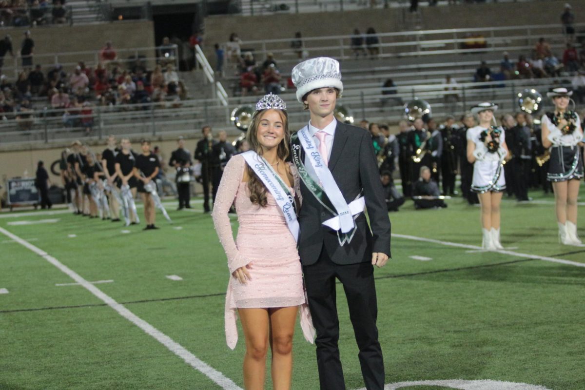 Smiling with their crowns and sashes, senior homecoming queen LuLu Lynch and senior homecoming king Reid Cummins pose for a photo together. Lynch and Cummins won the title over senior princes and princesses Isla Powell, Ella Baker, Jacob Slaughter and Noah Levy. “It’s like a scrapbook moment,” Cummins said. “It feels really weird and cool. It’s really crazy to have all these people looking at you.”