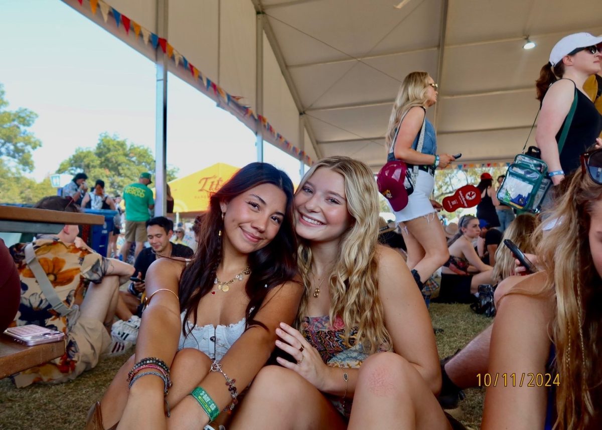 Sitting with her friend senior Sohpia Struve at last year’s Austin City Limits Festival, senior Ava Zuniga poses for a picture under a pavilion. They are frequent attendees at ACL, an annual music festival at Zilker Park. “I would recommend seeing a bunch of people,” Zuniga said. “This past year, we camped out for Chappell [Roan] for a really long time. I think the whole point of ACL, [which] is a lot of fun, is that you can go see so many different people, even if you don’t know them. So by camping by one person, it really limits yourself from being able to go see a bunch of people.” Photo courtesy of Ava Zuniga