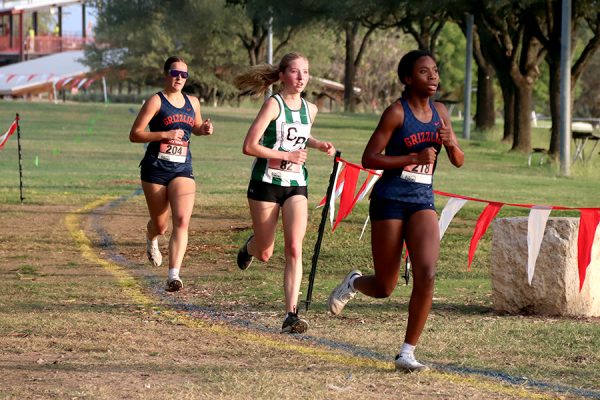 As her hair blows in the wind, senior Brianna Grandow runs the varsity girls 5K at the cross country district meet last Thursday. Grandow finished fourth in the event and led the varsity girls to regionals with a third place placement as a team. “I’m very excited [to go to regionals],” Grandow said. “I’m excited to race in Corpus Christi, and we get to go to the beach, so that’s really awesome.” Photo by Addison Bruce