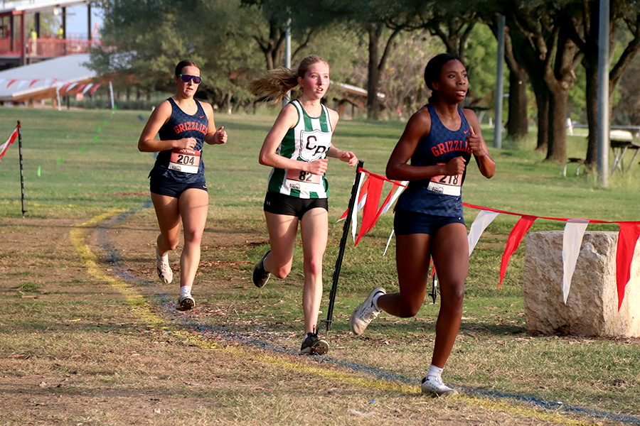 As her hair blows in the wind, senior Brianna Grandow runs the varsity girls 5K at the cross country district meet last Thursday. Grandow finished fourth in the event and led the varsity girls to regionals with a third place placement as a team. “I’m very excited [to go to regionals],” Grandow said. “I’m excited to race in Corpus Christi, and we get to go to the beach, so that’s really awesome.” Photo by Addison Bruce