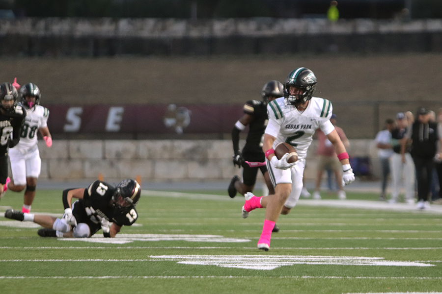 Running with the ball, junior wide receiver Jonah Johnson runs to the end zone for a touchdown at Friday's game against Rouse. Johnson scored two touchdowns during the game, which resulted in the Timberwolves' victory, 48-35. “We know when someone’s playing their homecoming game, that’s a sign that they’re trying to beat us,” Johnson said. “They’re 0-12 against us. They’re not going to beat us.” Photo by Natalia Saban