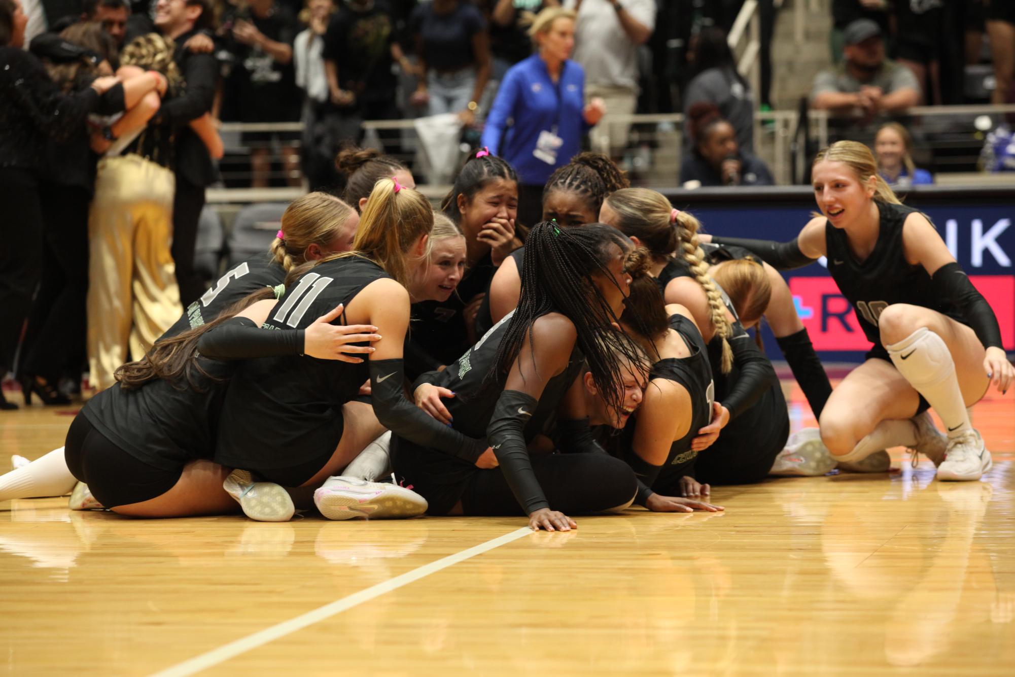 Huddled together, the volleyball team celebrates their win in the state title game together on Saturday. This was the fourth appearance in the state tournament for the Timberwolves but their first time winning the title. “It hasn’t even set in,” senior outside hitter Joy Udoye said. “I just can’t even believe we made history for the school, and we’re just so proud of each and every one of the girls on this team. I’m just super excited for them and us.”