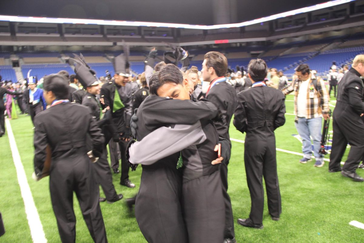 Hugging his friend and fellow band member, senior baritone player Ryan Chung celebrates after completing their performance at the UIL 5A State Championship. This is the band’s seventh year in a row winning first place. “What really kept me motivated was just all of the people,” Chung said. “I tried really hard to connect with as many people as I could in the band and I think that it really paid off because it motivated me to continue to inspire, continue to grow and connect with everybody I know. It truly didn't just motivate me, but it also pushed me to grow as a person as well.” 