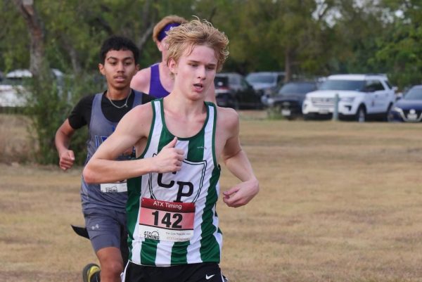  Senior Liam Snow pushes past opponents as he carries on in the race, helping bring the cross country team to victory. Snow has run cross country for four years. “I think that my consistency and progress I've made through that consistency pours into my teammates,” Snow said. “And I think that inspires more consistency through my teammates.”