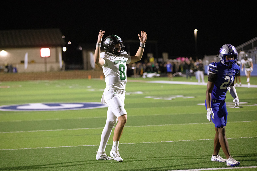 Hands up in the air, junior quarterback David Cooper celebrates a successful play in the district title-clinching win over the Georgetown Eagles. Cooper rushed for 146 yards and two touchdowns in the victory. “It was super fun,” Cooper said. “I love to run the ball. Hopefully, I can just keep doing that. I thought our team played great and had a lot of tenacity.”
