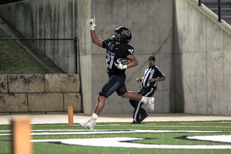 Pointing towards the sky, senior running back Trae Hill celebrates a touchdown, one of five for him in a 50-43 win over the Tyler Lions in the first round of playoffs. Hill broke the single-game and single-season school rushing records in the game. “It’s definitely rewarding,” Hill said. “Records are meant to be broken, and I’m here to break them. I thank the [offensive] line for everything. Half my runs, I was untouched, and I produced them when I could.” Photo by Nelson Phan