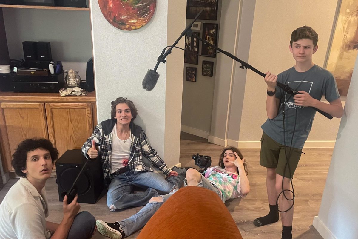 Seniors Arthur Ce, Ben Akers, Mia Morneault and sophomore Colton Alderman pose for a photo after finishing filming a scene. For Ce, this has been his second year going through the film process. “I’m so grateful for the reception that it ended up getting because last year when we filmed “Pumpkin Man”, we found out how harsh the judges can be,” Ce said. “So getting the scores back and seeing what the judges thought of this film, which is so much more crazy than last year, was very scary.” 