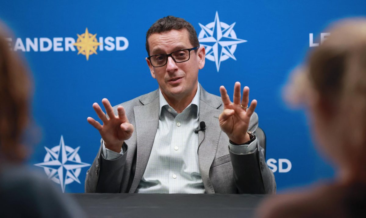Gesturing as he speaks, Acting Superintendent Dr. Chris Clark addresses student media at a press conference Tuesday. Clark pledged to prioritize stability and protect the student experience as Leander ISD faces a budget deficit and possible school closures. “The goal of not just mine but everybody in this district is to minimize the impact of any reductions we make on the student experience,” Clark said. “I would love to find a ‘magic bullet’ where we could remedy this deficit and kids would never know the difference. I know that’s not a reality so my biggest concern is that somehow the decisions that we make negatively impact any student.”
Photo courtesy of Griffin Darby