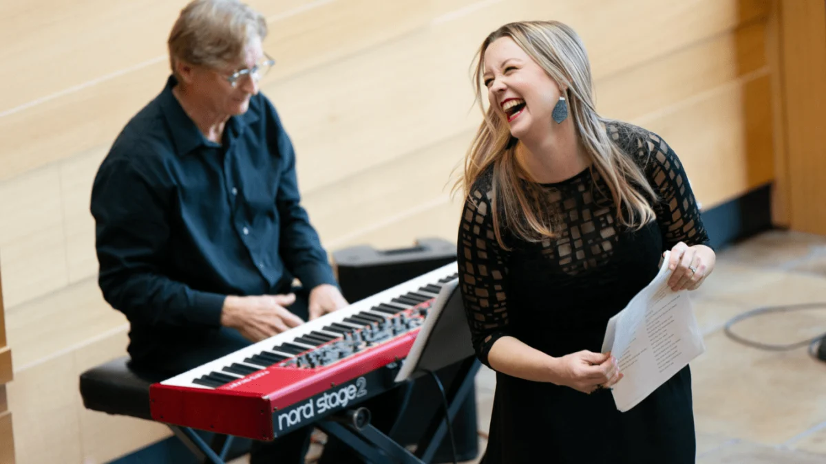 Smiling and laughing, choir teacher Lisa Holt stands next to a pianist. Holt was named a top 10 finalist for the Grammy Music Educator Award. “I think at this stage in my career I really want to share what I know with other people and not to keep anything a secret,” Holt said. “I want my playbook, if you call it that, to be available to everyone and let other people know what has worked in my room that might work for them and to continue to build up music education. Just in general, any kid that wants to sing, let’s get them the resources to sing well.” Photo Courtesy of SoCo Women's Chorus