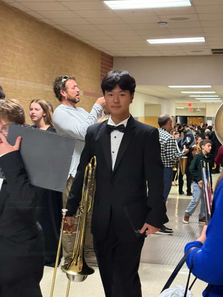 Dressed for his performance, freshman trombone player Seowoong Chang gets ready to perform in the TMEA Region 32 concert. “I'm really proud of [my progress],” Chang said. “I see a big difference in my playing from my [eighth-grade] year to my freshman year. Next year, I'm going to try to organize more of my practice sessions to know what I'm going to do and try to put more time into my practice.” Photo courtesy of Seowoong Chang