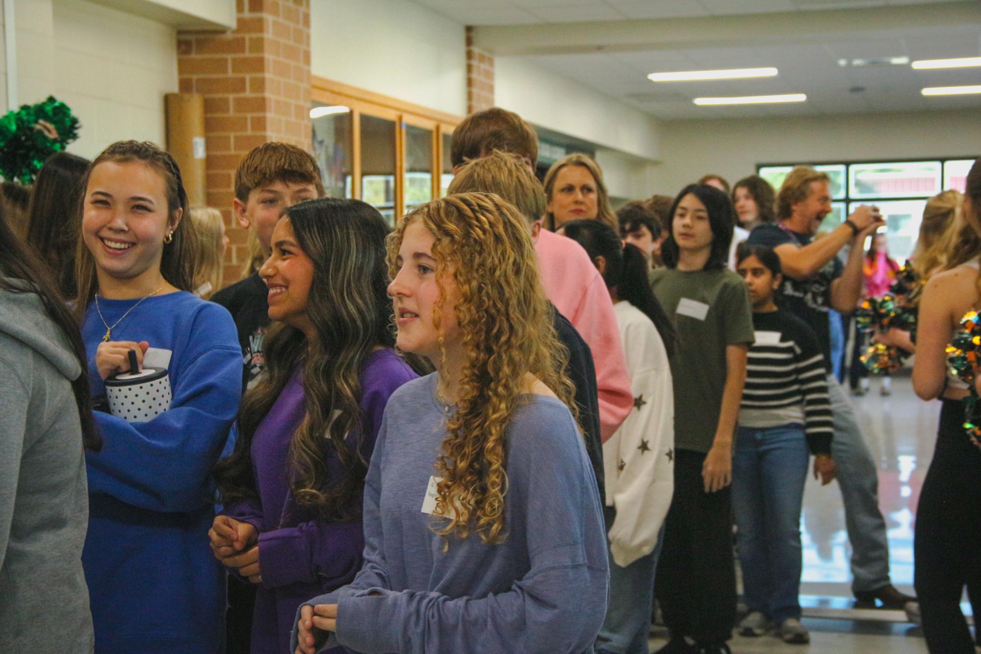 Eighth graders make their way to the gym for the Eighth Grade Invasion pep rally. This is the tenth annual Eighth Grade Invasion. “It is fun to talk about our customs, our legacy and our history and to just welcome them to be a part of the Timberwolf family,” PALS teacher Jared Lippe said.