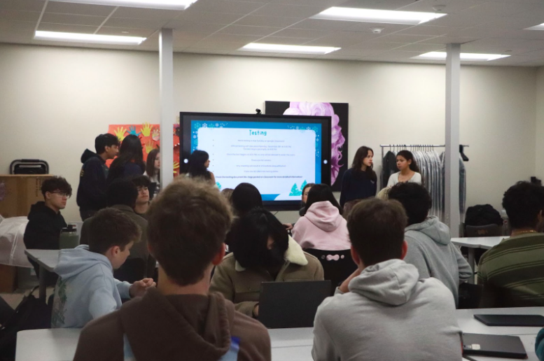 Sitting at desks, DECA members gather to discuss this year’s competition requirements. Earlier this semester, all members were required to take and pass a 50-question business administration exam with a score of at least 70% before registering for any district conferences. “It was surprising,” DECA competitor Joshua Wicketts said. “They told us everyone had to pass the test, no matter which event we’re doing, so a lot of us had to quickly shift our focus and study for it.”