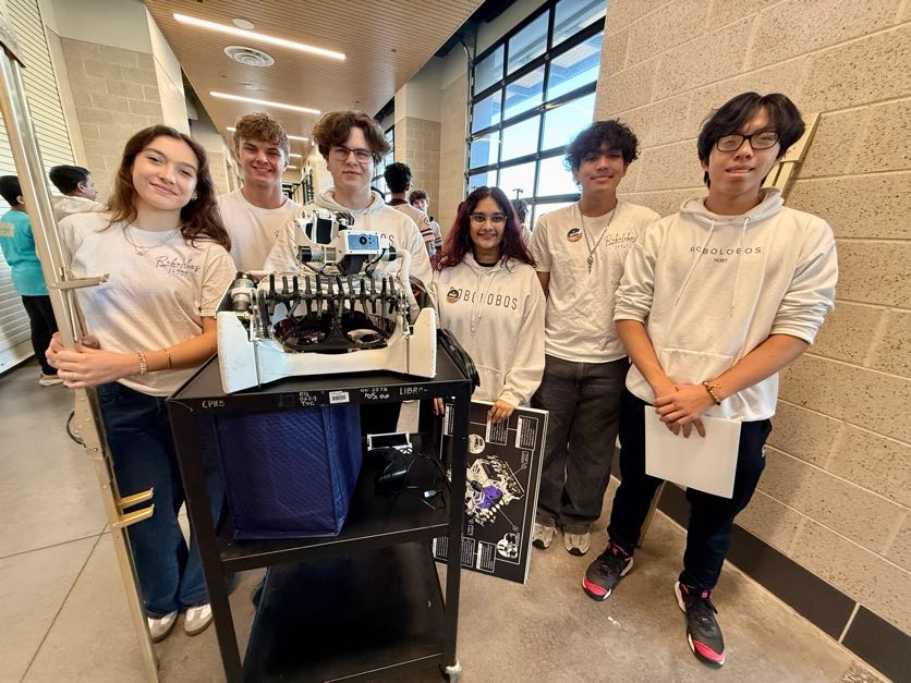 Posing with their robot, the Robolobos Fenrir members celebrate a strong season at state. The team won the 5A state championship for the fourth year in a row on March 20. “It’s really rewarding to see all the work come together,” junior vice president Grayson Lerche said. “We’ve been able to stay successful because our program keeps improving and focusing on long term growth. We really try to build something that lasts, not just for one season but for years to come.” Photo Courtesy of Amy Lovelace