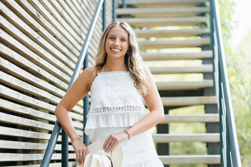 Holding a cowboy hat, senior cheer captain Katie Foster smiles at the camera. Foster has been a captain since her junior year, helping to lead them to a 10th place finish at nationals. “Cheer has entirely made me who I am,” Foster said. “From volunteering, to social skills, to friendships and hard work, cheer has rounded me and showed me what I value most. I think everyone should be held to a standard that makes them a better person, and I'm so grateful to have been pushed to be better physically and mentally.” Photo courtesy of Katie Foster
